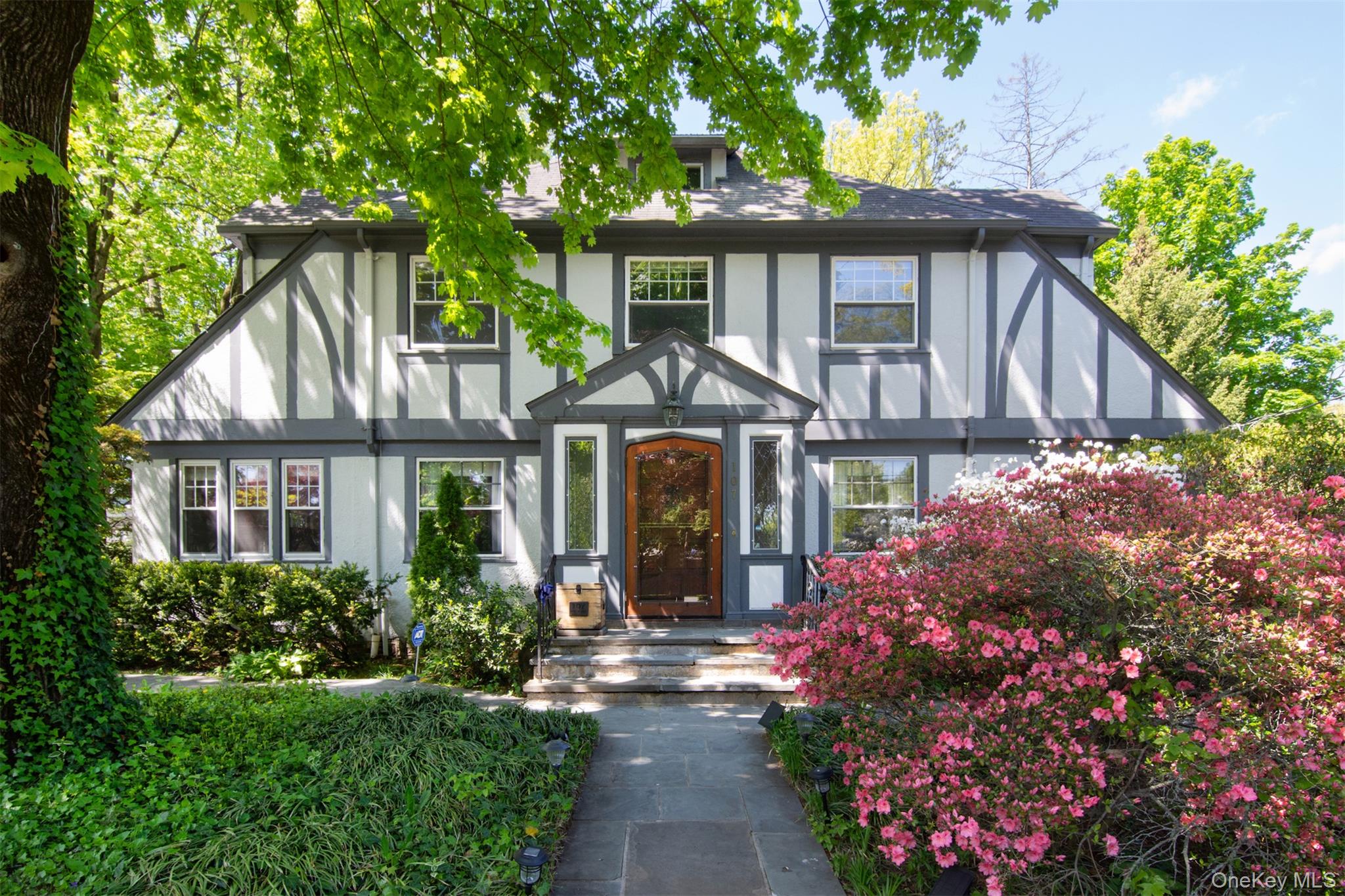 Just in time for summer parties on the patio, this Tudor-style home in...