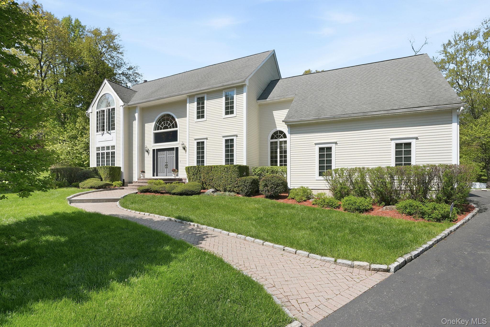 Beautifully updated center hall Colonial, set on a private and profess...