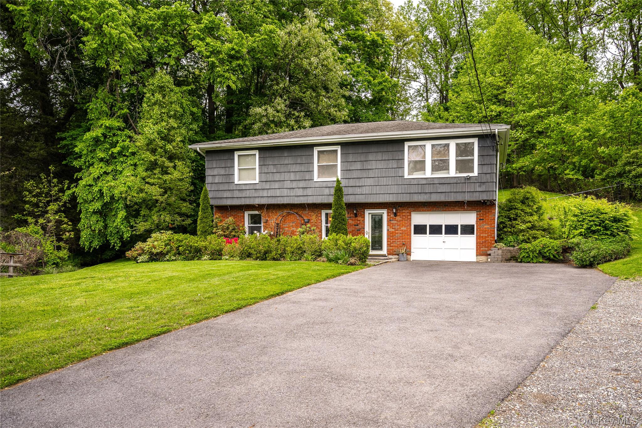 VERSATILE "HIGH RANCH" HOME NESTLED INTO GENTLE ROLLING HILLSIDE.  SOU...