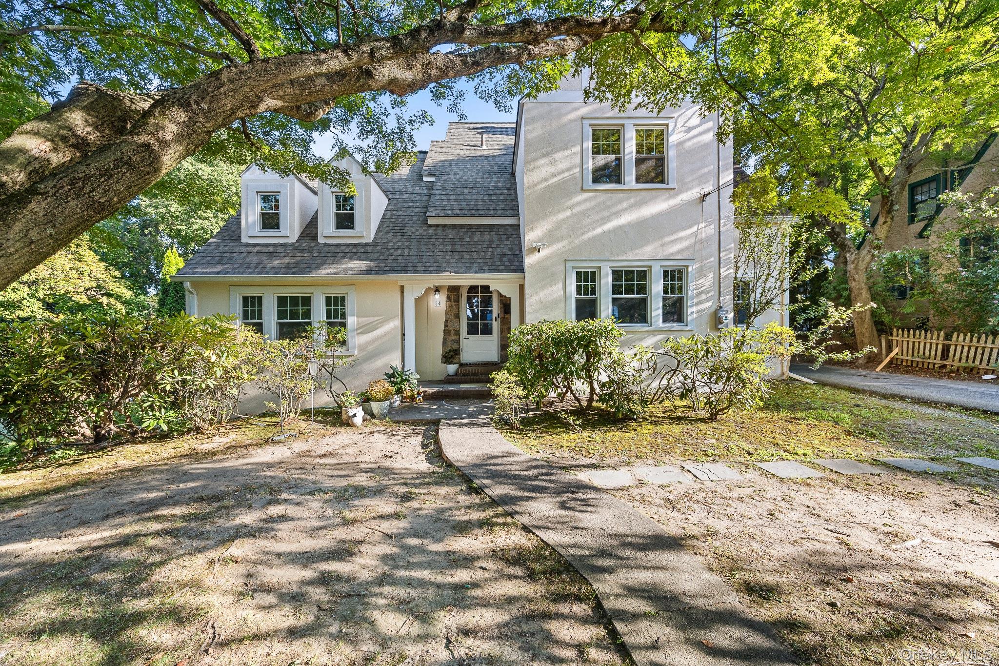 Nestled on a beautifully landscaped third of an acre at College Corner...