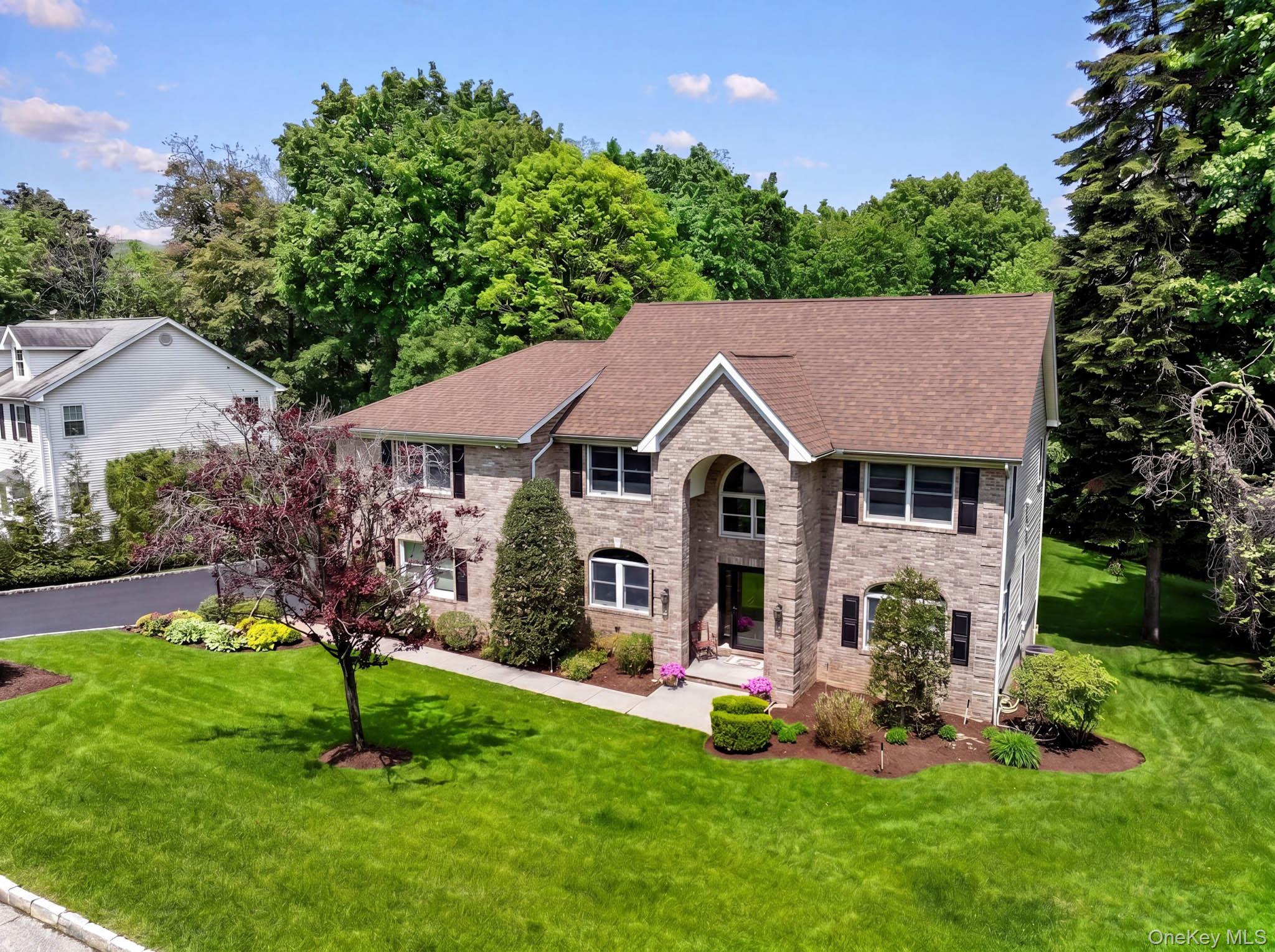 Welcome to 8 Drake Lane, a beautifully updated brick Colonial set on n...