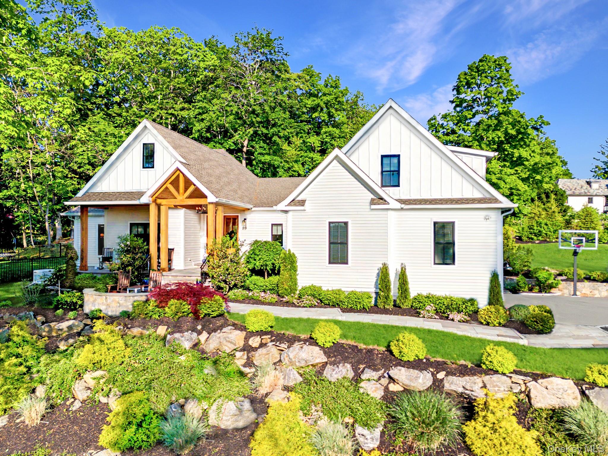 Tucked away on over two exquisitely landscaped acres in one of Chappaq...